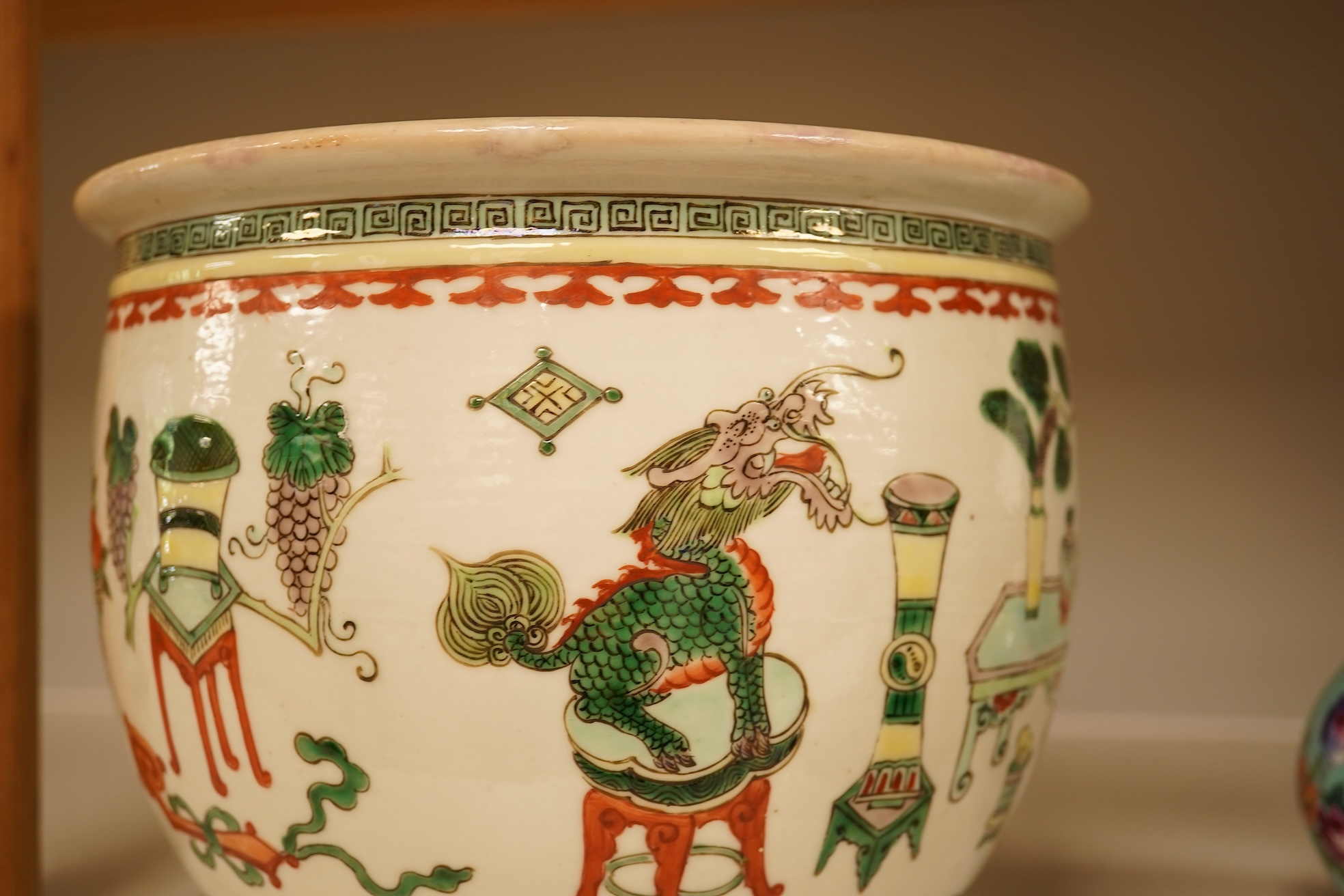 A Chinese Hundred Antiques famille verte small jardiniere, 19th century, 17cm high, 21cm diameter.